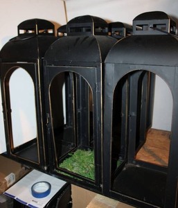 lot 59 image: (7) Lanterns 22 Tall and 9 square base - some have glass panels (water bottle in picture is for size comparison)