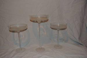 lot 198 image: (3) Clear Glass long-stemmed candle holders - (2) 11x7.5x1.25 lip, (1) 15x7.5x1.25 lip