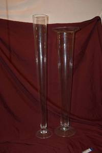 lot 117 image: (2) Clear Glass Pilsner Vases - (1) 5x39, (1) 9x35