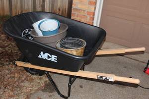 lot 10 image: Ace Wheelbarrow (barley used) and various planters as pictured
