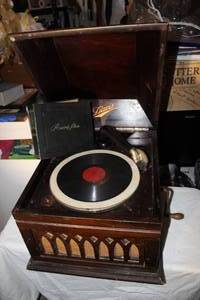 lot 19 image: $$ Vintage Davis Victrolla and Vintage Album Full of 45 Records, Crank works and Turntable Spins, will need a Needle.