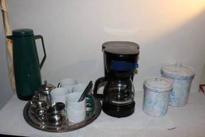 lot 99 image: Hamilton Beach 5 Cup Coffee Pot, Carafe, 2 Canisters and 4 Strawberry Street Ltd Coffee Mugs, Stainless Steele Tea pot Creamer and Sugar Set and other Hoouse Ware items shown in pictures