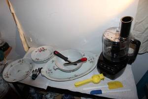 lot 101 image: Black & Decker, Black Food Processor and a few cooking utensils as shown Serving Platter, Bowl and 1 Plate Ucagco China 4 White China plates with Pink flowers are unmarked