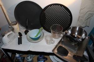 lot 102 image: Various Bakeware, Pizza Pans, Cookie Sheet, Glass Pyrex Measuring Cup, Hamilton Beach hand Mixer, Krups Grinder, Melon Baller and other various utensils, 1 small pyrex bowl clear glass, and small white Fransican Bowl