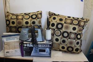 lot 239 image: Black and Decker Iron, Clothes Pins with cotton Cloth bag, and Decorative Throw Pillows in style as shown