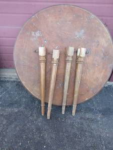 lot 97 image: 42 brown oval wooden dining table, needs to be sanded and repainted or stained, has the 4 legs with it , still very sturdy