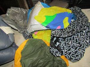 lot 104 image: medium size sleeping bag well used blue in color, large lot of used inflatable floats for swimming pool or lake use, tubs and more