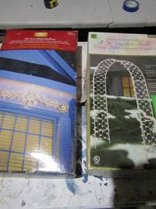 lot 108 image: 5ft snowflake roofline in box, 8 ft. garden arch with 200 woven lights in original box