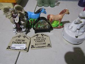 lot 114 image: 2 clay handmade horses one brown the other one is blue, girl with a unicorn music box, angel playing the harp and 2 home dcor signs