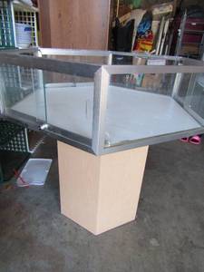lot 3 image: Glass display case open at the top,  sits on a wooden stand all together one piece, no keys, size- 36 tall 34 HEXAGON Good condition