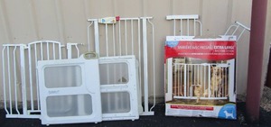 lot 182 image: used dog child gates, qty 4 various styles, all white in color, 2 have small animal crawl threw doors