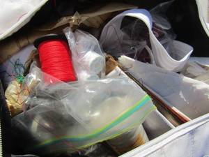 lot 71 image: white bag full of sewing items and fabric