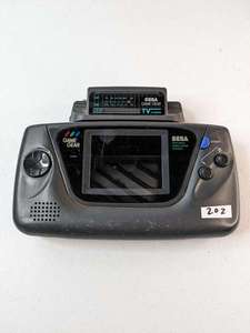 lot 202 image: SEGA Game Gear Handheld System 2110 w Game Gear TV Tuner MK-2101 - For Parts