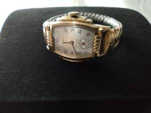 lot 105 image: 10K Rolled gold Benrus Endurable art deco watch. Swiss movement w stepped case. Crystal dome. Marked 10K rolled gold on reverse. Model 761218. JB Stainless two-tone flex band. Recessed seconds sub dial at the 6.