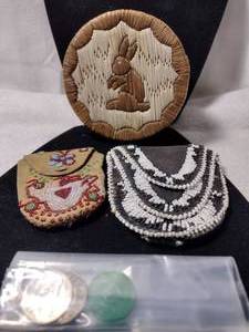 lot 112 image: Vintage to antique lidded grass basket with rabbit motif, (2) beaded leather satchelspurses and tokens (Colorado, Indiana and Missouri)