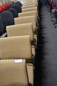 lot 103 image: (8) Gold checkered rolling office chairs