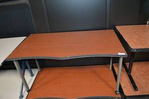 lot 91 image: (2) Wood-like laminate Tables with double curves on front, sits on wheels - 54W x 30D x 29H