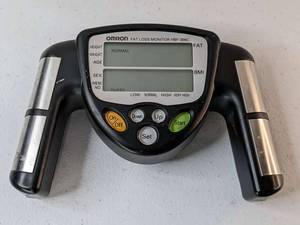 lot 227 image: Omron HBF-306CN Handheld Body Fat Loss BMI Monitor