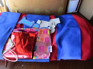 lot 214 image: red & blue hanging bag full of birthday & Christmas wrapping paper and gift bags, new and used