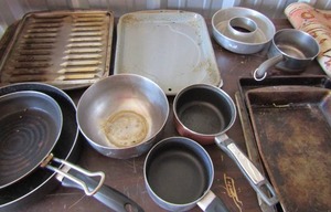 lot 215 image: Used lot of sauce pans-- baking pans and cookie sheets