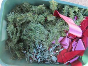 lot 277 image: Green tote full of Christmas greenery and lights plus a few decretive bows
