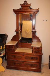 lot 8 image: Antique Dresser with attached mirror, wooden wheels and marble tops, see pictures - 44W x 19D x 7ft. Tall