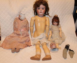 lot 7 image: Vintage porcelain head dolls with plastic hinge body and joints, see pictures with red Germany 6 stamp, includes extra porcelain head