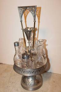 lot 10 image: 6-jar dining table serving set with silver caddy, some glass has chips, see pictures