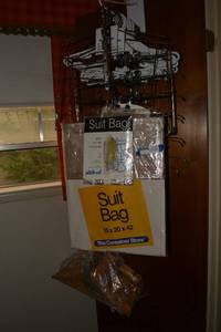 lot 79 image: Closet Lot Suit bags, wooden hangers and pantmulti-hangers (some look unused)