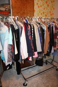 lot 28 image: Rolling clothes rack PLUS clothes (Generous amount, many still have tags)