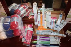 lot 32 image: Knitting needles multiple sizes and red, white and blue yarn SIP