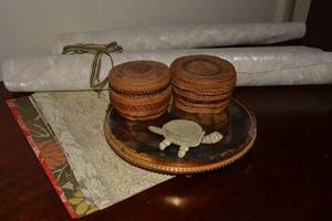 lot 75 image: Vintage Mirrored swivel Tray with bobble head turtle pin cushion, Native American Woven Trinket baskets with lids and wallpaper remnants