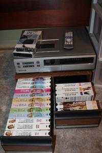 lot 142 image: Exercise VHS collection and Panasonic VCR player with remote