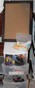 lot 143 image: Plastic storage tote with office supplies and framed cork board