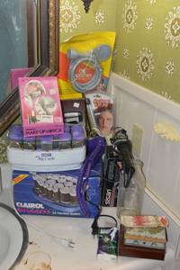 lot 195 image: Bathroom lot rollers, curling iron, make-up mirror, lint roller, shower attachment