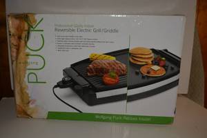 lot 261 image: Reversible Electric GrillGriddle by Wolfgang Puck. Box got wet but inside is still in packaging