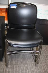 lot 103 image: (4) Stackable black plastic chairs with chrome legs
