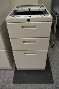 lot 139 image: Knoll under desk file cabinet with plastic mat for underneath