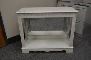 lot 148 image: Vintage white entry table with mirrored back (has a light underneath but cord plug is cut off, needs repair)