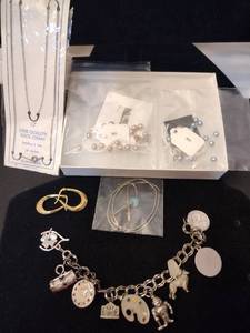 lot 118 image: Jewelry Sterling Silver selection. Includes (2) Lee Sands pearl button pearl necklaces, stainless steel charm bracelet with some sterling charms, 18L necklace, Heshi silver liquid bead turquoise necklace, gold over silver hoop earrings,