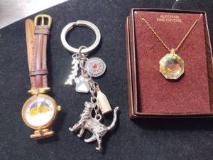 lot 201 image: Jewelry Fossil Watch Model PC-9234 with moon phase image, Austrian crystal boxed necklace and cat themed keychain.