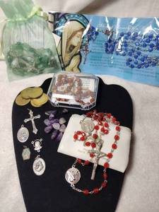 lot 203 image: Jewelry Religious and rosary jewelry. Includes a Pope John Paul II (May 18, 1920-April 2, 2005) commemorative rosary with pouch (zipper needs attention). Also includes Angel tokens, medallions plus