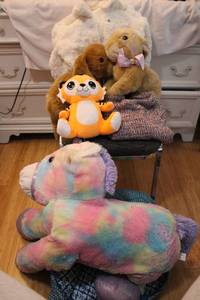 lot 211 image: Kids stuffed animals, laundry bag, sweater and furry white coat