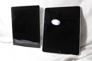 lot 228 image: (2) Apple ipads. One screen is cracked, working condition unknown.