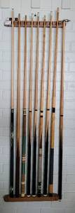 lot 70 image: LOT OF POOL CUES WITH WALL MOUNTED HOLDER AS SHOWN.