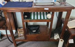 lot 94 image: WOODEN TABLE IN STYLEDESIGN SHOWN. APPROX. 48 X 42 X 16 CONTENTS NOT INCLUDED.