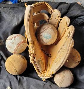 lot 184 image: LOUISVILLE SLUGGER BIG DADDY GLOVE AND SOFTBALLS AS SHOWN.