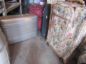 lot 54 image: silver suitcase, red swiss suitcase with wheels, black rolling suit case, floral suit case with wheelshandles