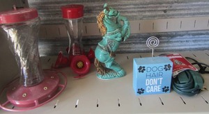 lot 70 image: 2 humming bird feeders, 10 in dcor horse standing on back legs, new 9 outlet extension cord, intex air mattress inflator