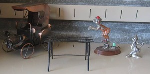 lot 81 image: pewter clown playing guitar, small metal clown, small metal bench, metal music box car